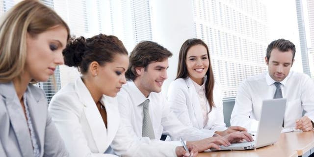 Office workers interacting on a project. Always try to beat deadlines, said a performance adviser.