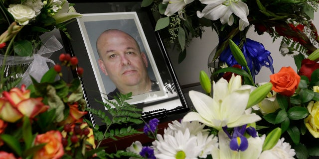 FILE: Flowers surround a photo of slain Sacramento County Deputy Sheriff Daniel Oliver. (AP)