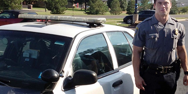 Sept. 2, 2012: In this file photo, provided by the Oklahoma Police Dept., Oklahoma City police officer Daniel Holtzclaw stands next to his vehicle.