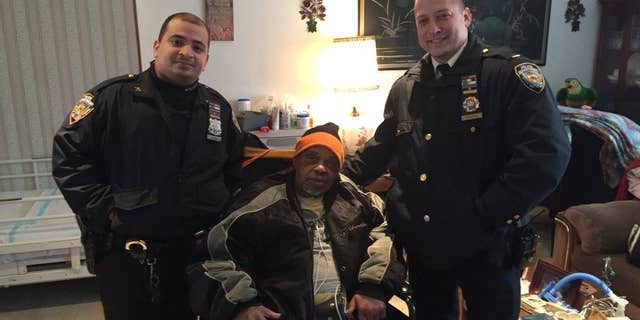 NYPD Lt. Vitaliy Zelikov (left) and Officer Georin Duran (right) pose with an 85-year-old man who says he was a Navy veteran.