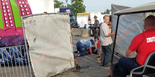 A person is attended to as authorities respond after the Fire Ball amusement ride malfunctioned injuring several at the Ohio State Fair, Wednesday, July 26, 2017, in Columbus, Ohio.