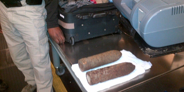 This Monday, April 7, 2014 photo provided by the Transportation Security Administration (TSA) shows two World War I artillery shells discovered by baggage screeners in checked luggage that arrived on a flight from London at Chicago's O'Hare International Airport. The TSA says the bags belonged to a 16-year-old and a 17-year-old who were returning from a school field trip to Europe. A bomb disposal crew determined the shells were inert and no one was ever in danger. The teens were questioned then allowed to travel onward. They weren't charged. (AP/Transportation Security Administration)