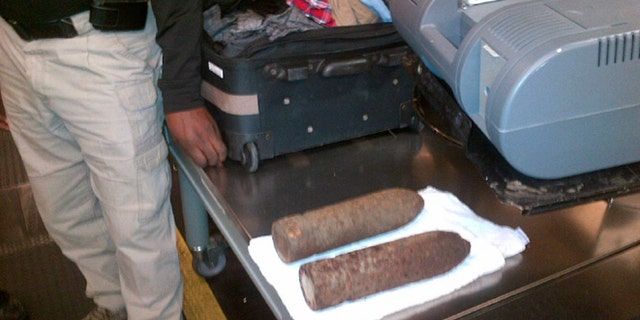 This Monday, April 7, 2014 photo provided by the Transportation Security Administration (TSA) shows two World War I artillery shells discovered by baggage screeners in checked luggage that arrived on a flight from London at Chicago's O'Hare International Airport. The TSA says the bags belonged to a 16-year-old and a 17-year-old who were returning from a school field trip to Europe. A bomb disposal crew determined the shells were inert and no one was ever in danger. The teens were questioned then allowed to travel onward. They weren't charged. (AP/Transportation Security Administration)
