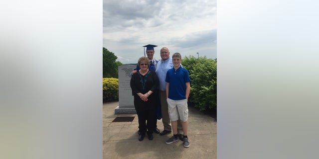 East Liverpool High School graduate Bobby Hill with his grandmother Barbara Hill, father Robert and brother Jonathan.