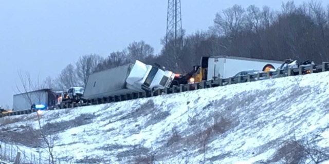 A semi-truck is tipped over after a massive pileup on an Ohio interstate caused by a snow squall.