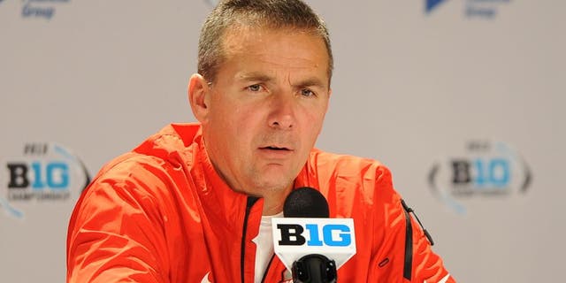 INDIANAPOLIS, INDIANA - DECEMBER 7, 2013: Head coach Urban Meyer of the Ohio State Buckeyes answers questions from the media during the post game press conference after a game against the Michigan State Spartans at Lucas Oil Stadium in Indianapolis, Indiana. The Spartans won 34-24. (Photo by David Dermer/Diamond Images/Getty Images)