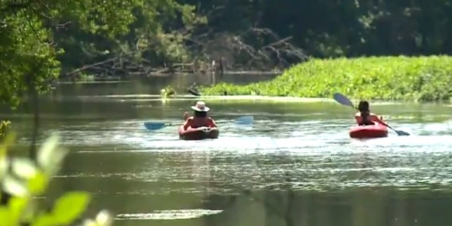 The teammates rescued the elderly couple from the Cuyahoga River in Ohio.