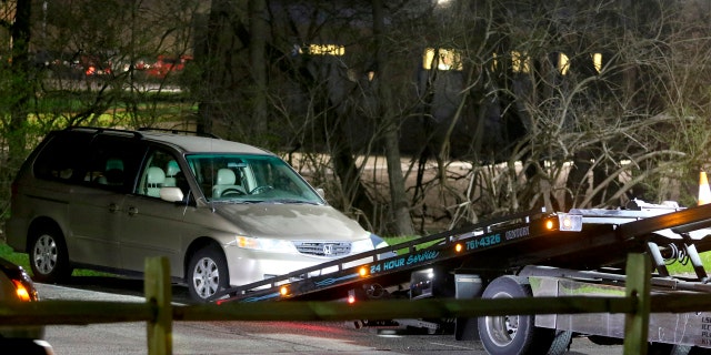 In this April 10, 2018 photo, a minivan is removed from the parking lot near the Seven Hills School campus in Cincinnati.