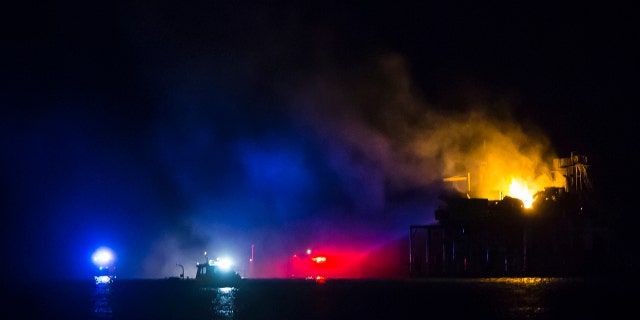 Rescue boats surround a rig in Lake Pontchartrain near New Orleans, La., after the rig exploded late on Sunday, Oct. 15, 2017.