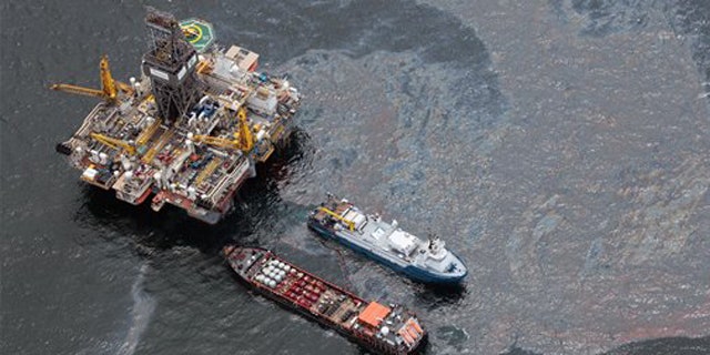 July 16, 2010: Workboats operate near the Transocean Development Drilling Rig II at the site of the Deepwater Horizon incident in the Gulf of Mexico. The wellhead has been capped and BP is continuing to test the integrity of the well before resuming production.