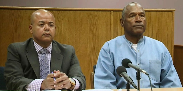 Former NFL football star O.J. Simpson appears with his attorney, Malcolm LaVergne, left, via video for his parole hearing at the Lovelock Correctional Center in Lovelock, Nev.
