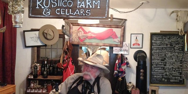 Owner Bruce Fuller, owner of Rustico Farm & Cellars, wearing his a worn cowboy hat.