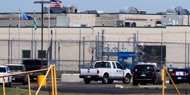 A GEO corrections vehicle drives past the front gate of the Great Plains Correctional Facility in Hinton, Okla, Monday, July 10, 2017.
