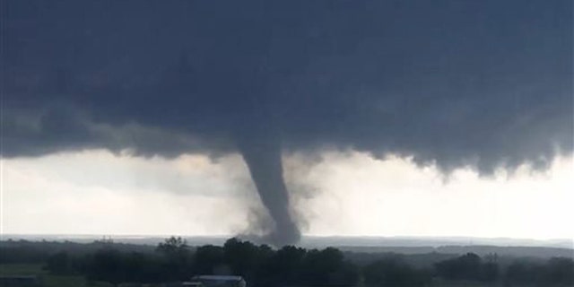 This image made from a video taken through a car window shows a tornado near Wynnewood, Okla., Monday, May 9, 2016.