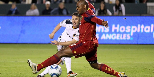 CARSON, CA - NOVEMBER 06: Robbie Keane #14 of the Los Angeles Galaxy gets a shot past Jamison Olave #4 of Real Salt Lake to score the Galaxy's third goal in the MLS Western Conference Championship at The Home Depot Center on November 6, 2011 in Carson, California. The Galaxy won 3-1 to advance to the MLS Cup. (Photo by Stephen Dunn/Getty Images)