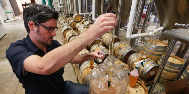 Co-Owner of Ardent Craft Ales, Kevin O'Leary, takes a sample of Persimmon beer at the facility in Richmond, VA.