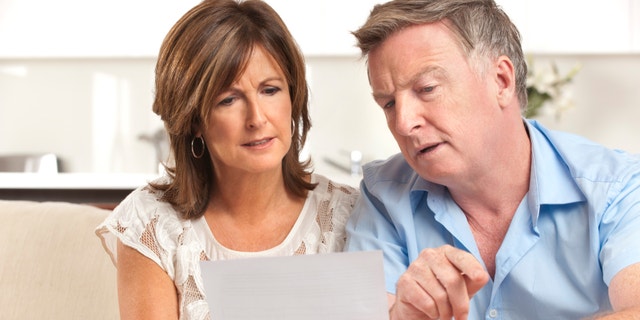 Mature couple worrying about finances at home