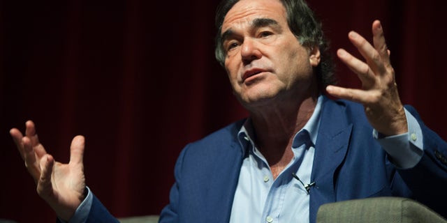 Oliver Stone was accused of grabbing a former Playmate's breast.