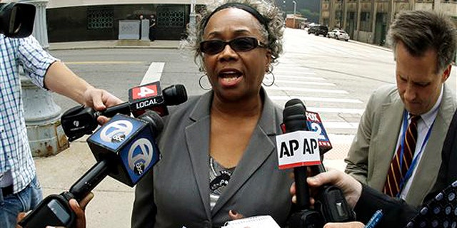 Sept. 19, 2013: Detroit resident Olivia Gillon addresses the media outside federal court in Detroit after attending a Detroit bankruptcy hearing.