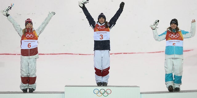 Gold medalist Perrine Laffont of France, silver medalist Justine Dufour-Lapointe of Canada and bronze medalist Yulia Galysheva of Kazakhstan celebrate after the women's moguls competition.