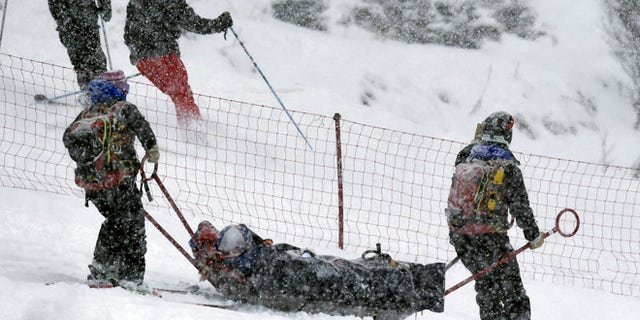 Lindsey Vonn, of the United States, is being carried out of the course on a rescue sled after falling during a women's World Cup alpine ski super G race, in Soldeu, Andorra, Saturday, Feb. 27, 2016. (AP Photo)
