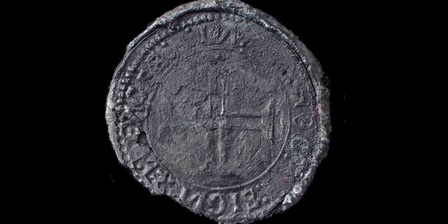 This undated photo made available by Blue Water Recoveries company on Tuesday, March 15, 2016 shows a rare silver coin called an Indio discovered from the debris of the explorer Vasco da Gama's ship, Esmeralda which sank in a storm in May 1503 off the coast of Al Hallaniyah island in Oman's Dhofar region. (Blue Water Recoveries company via AP)