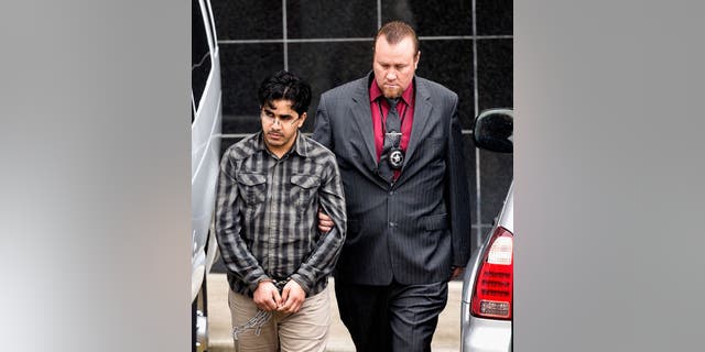 Omar Faraj Saeed Al Hardan, left, is escorted by U.S. Marshals from the Bob Casey Federal Courthouse on Friday, Jan. 8, 2016, in Houston.