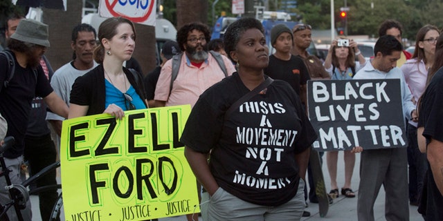 FILE 2015: Protestors carry signs during a demonstration by "Black Lives Matter" in Los Angeles.
