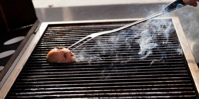Stock-photography services have MULTIPLE photos of people cleaning grills with onions, so you just know it's a real thing.