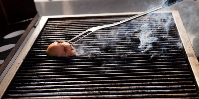Stock-photography services have MULTIPLE photos of people cleaning grills with onions, so you just know it's a real thing.