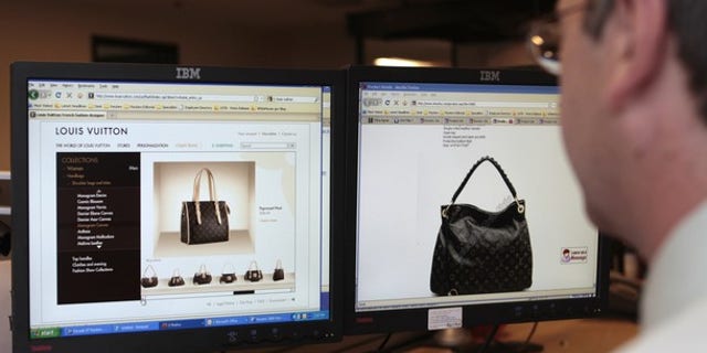 Reuters journalist Doug Palmer purchases a fake LVMH handbag from a China-based online website, from the Reuters office in Washington, September 10, 2010. (Reuters)