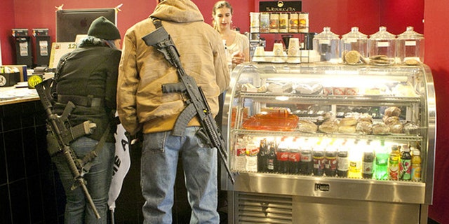 December 7, 2013: Stephanie McDonald and James Franklin buy coffee while participating in an open carry demonstration in Texas (AP).