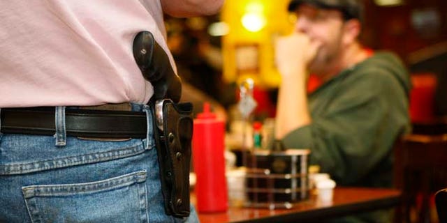 FILE: A man in Oklahoma wears an unconcealed side arm. The Texas House of Representatives on Friday voted 96-35 to allow residents with concealed-handgun licenses to openly carry their guns in public in holsters.