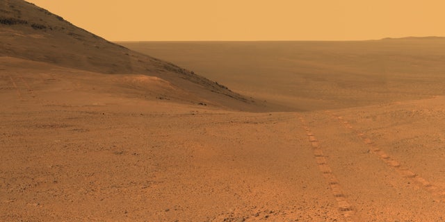 Tracks from NASA's Opportunity rover on Mars are visible on the Martian surface in this image taken in June 2017. After months of silence from Opportunity due to a dust storm on Mars, NASA has begun a 45-day campaign to reestablish contact with the rover.