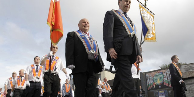 July 12, 2012: Orange Order members march past the mainly Catholic Ardyone area of North Belfast, Northen Ireland.