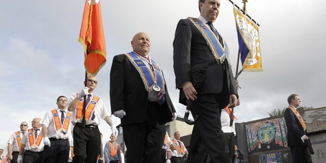 July 12, 2012: Orange Order members march past the mainly Catholic Ardyone area of North Belfast, Northen Ireland.