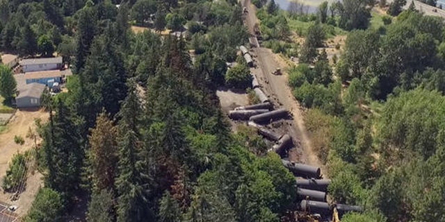 This video image taken from a drone shows an aerial view of crumpled oil tankers lying beside the railroad tracks after a fiery train derailment on June 3 prompted evacuations from the tiny Columbia River Gorge town about 70 miles east of Portland, on Monday, June 6, 2016, in Mosier, Ore.