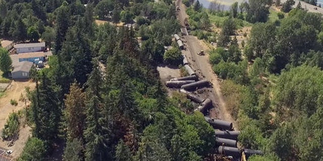 This video image taken from a drone shows an aerial view of crumpled oil tankers lying beside the railroad tracks after a fiery train derailment on June 3 prompted evacuations from the tiny Columbia River Gorge town about 70 miles east of Portland, on Monday, June 6, 2016, in Mosier, Ore.