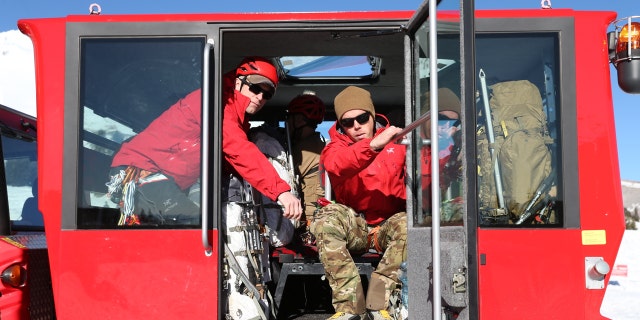 Rescuers depart Timberline Lodge in a snow tractor on Tuesday. Icy conditions complicated efforts to reach a fallen climber and rescue stranded ones on the mountain.