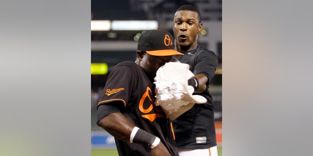 Felix Pie, left, is hit in the face with a shaving cream pie by Orioles teammate Adam Jones.