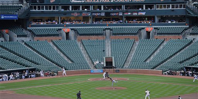 The Baltimore Orioles bat against the Chicago White Sox during a baseball game without fans Wednesday, April 29, 2015, in Baltimore.