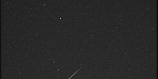 An Orionid meteor streaks across the night sky over Huntsville, Ala., in this view from a camera at NASA's Marshall Space Flight Center before dawn on Oct. 21, 2012.