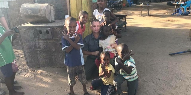 Former Army Reserve Lt. Col. Jason Souza collected 600 pairs of shoes and clothes for the children.