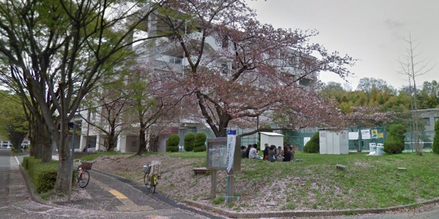Students sitting outside of Osaka University campus in Japan.