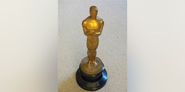 This undated photo released by Briarbrook Auctions shows an Academy Award Oscar statue awarded for color art direction in 1942 to Joseph C. Wright for his work on My Gal Sal.
