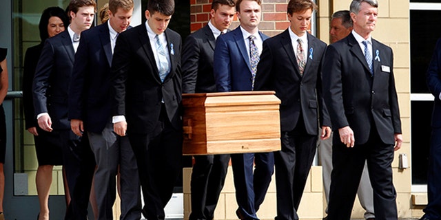 June 22, 2017: The casket of Otto Warmbier is carried from Wyoming High School after his funeral.