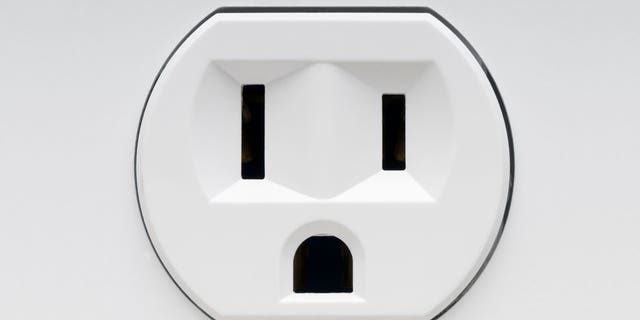 An prankster tricked passengers with a fake outlet sticker.