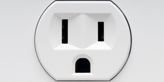 An prankster tricked passengers with a fake outlet sticker.