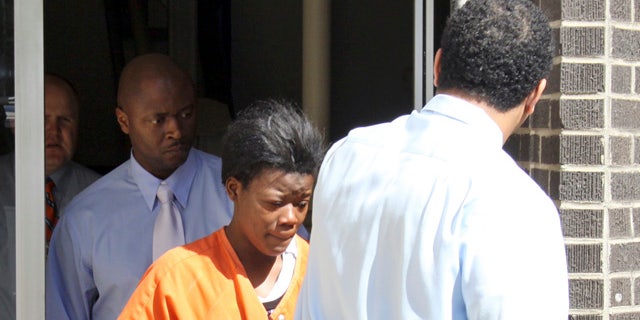 March 3: Police detectives escort Terrie A. Robinson, center, from the Greenville, Miss. Municipal Courthouse following her initial hearing. A judge has set bond at $5 million for Robinson, who is charged with murder in the death of her 3-year-old son whose body was found in an oven. A coroner said she found evidence of a trauma that is inconsistent with the inside of the oven, and that it's unclear whether the child was already dead when he was placed in the oven. (AP)