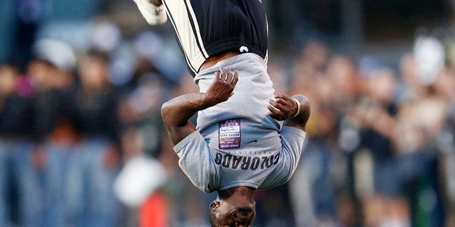 Ozell Williams performs a somersault as part of pre-game ceremonies before a University of Colorado football game.